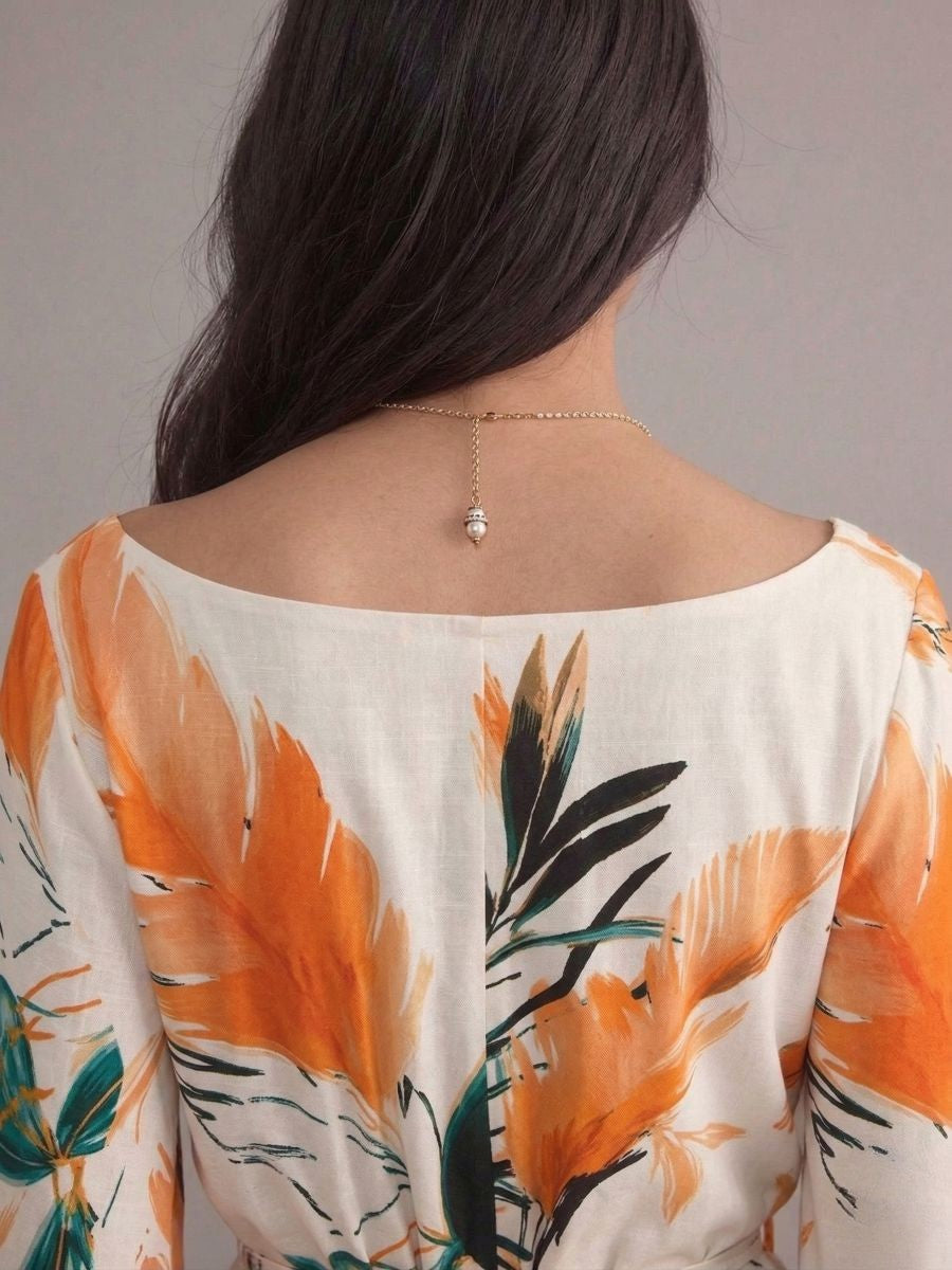 Robe bohème blanche et orange col en V manches chauve-souris imprimées